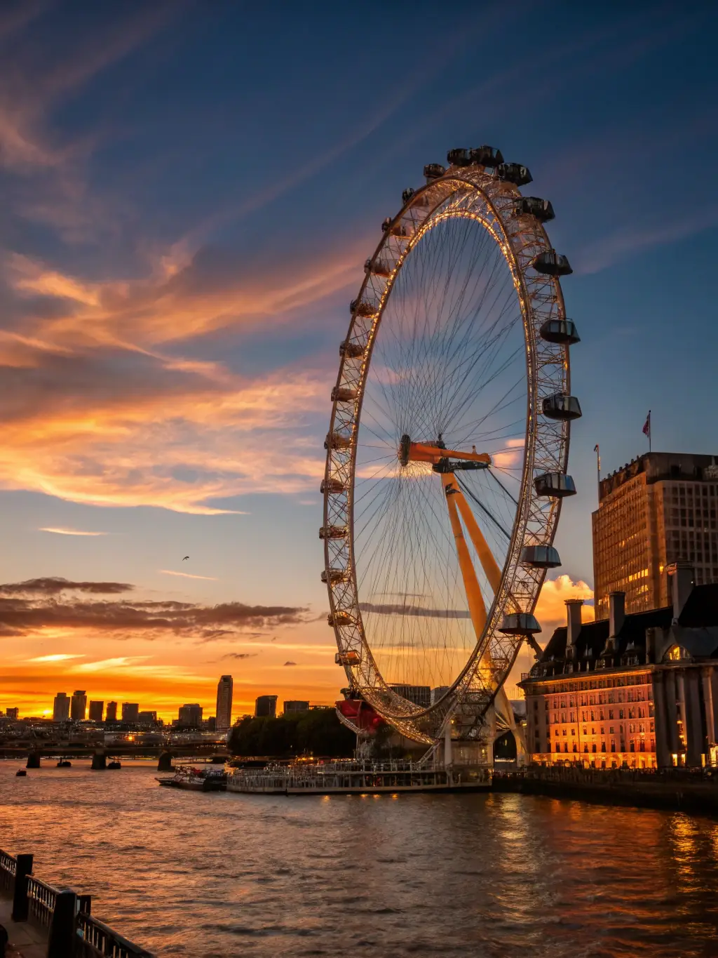 A serene landscape photograph of the River Thames at sunset, with the photographer using long exposure to create a smooth and dreamy effect.