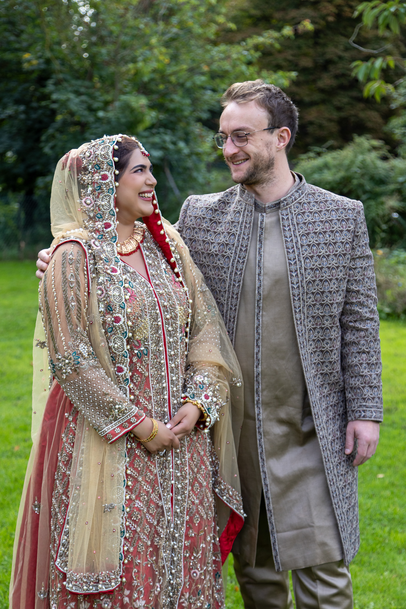 Asian Bride looking with a lovely way to his English Groom